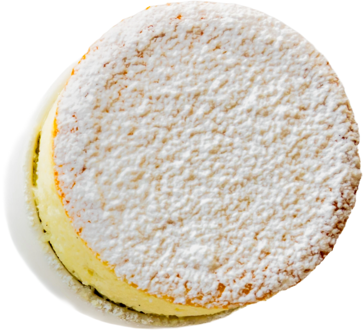 A round tart, thickly dusted with icing sugar, photographed from above against a plain background.